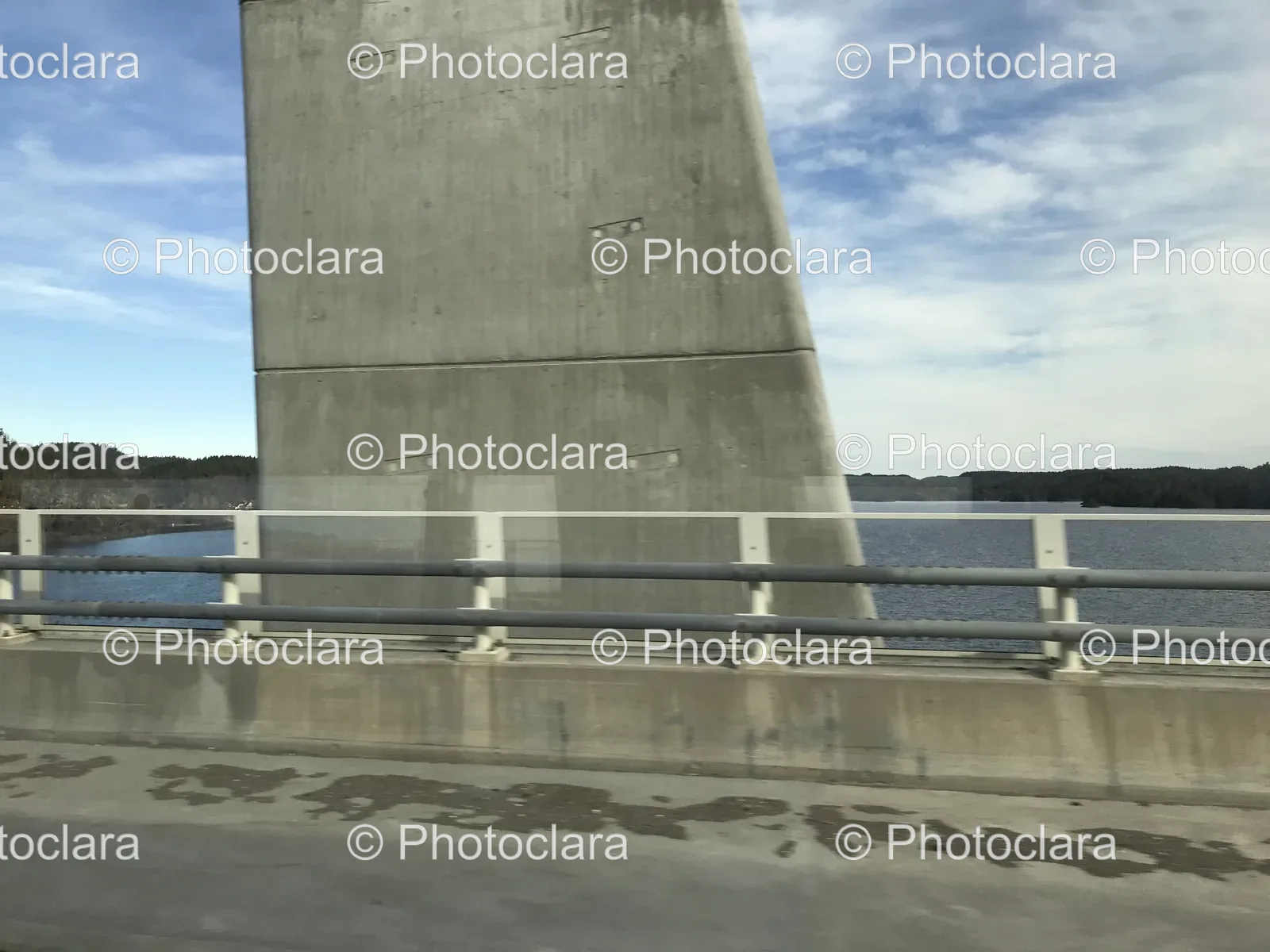 Concrete-Bridge-Over-Water-with-Cloudy-Sky.jpg