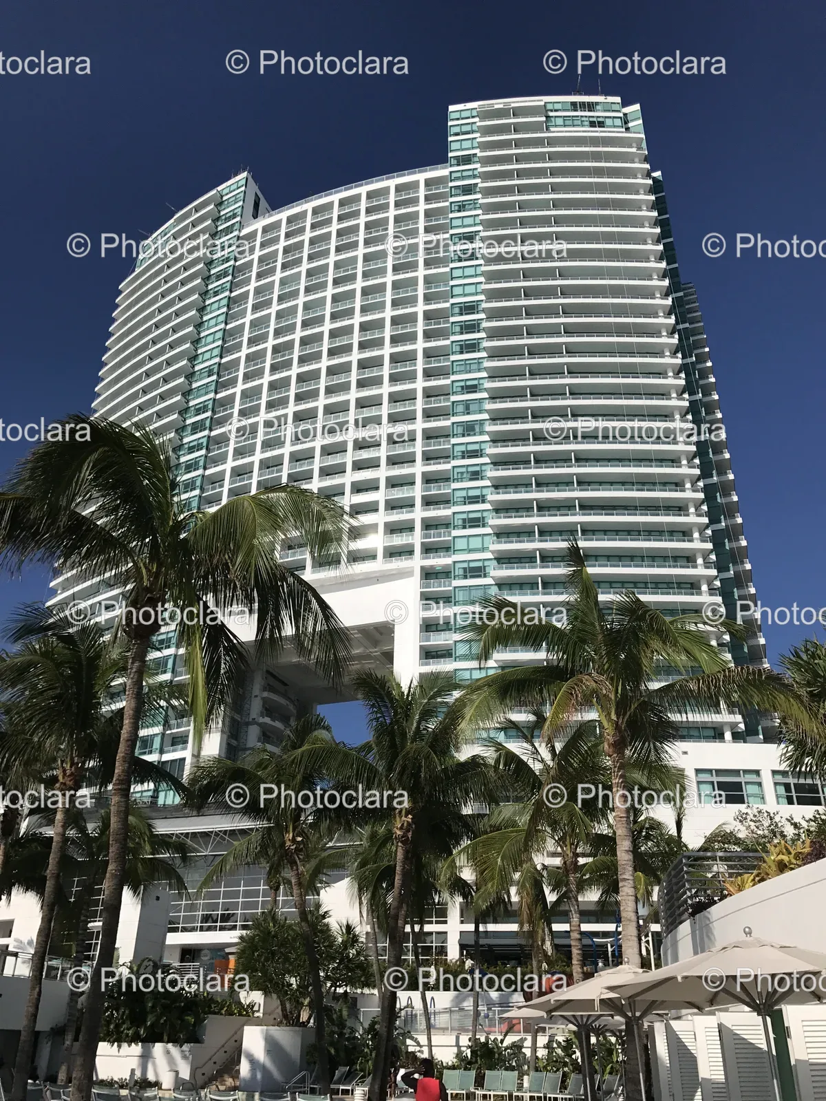 Tall White Building with Palm Trees