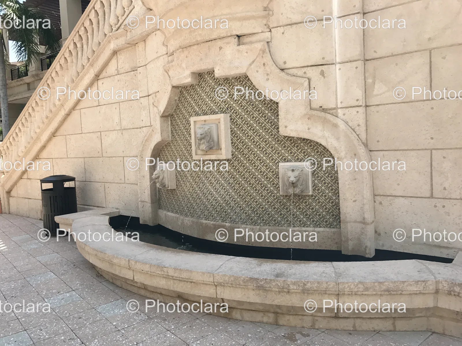 fountain-with-lion-heads-on-stone-wall.jpg