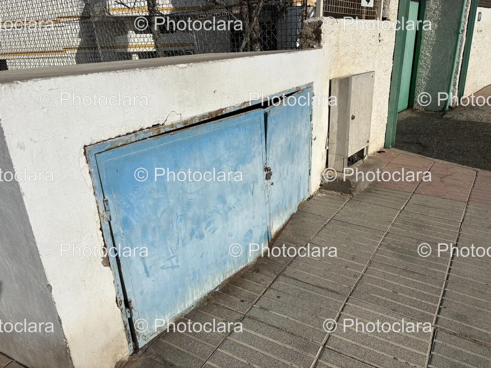 Blue-Metal-Door-on-Cement-Wall.jpg