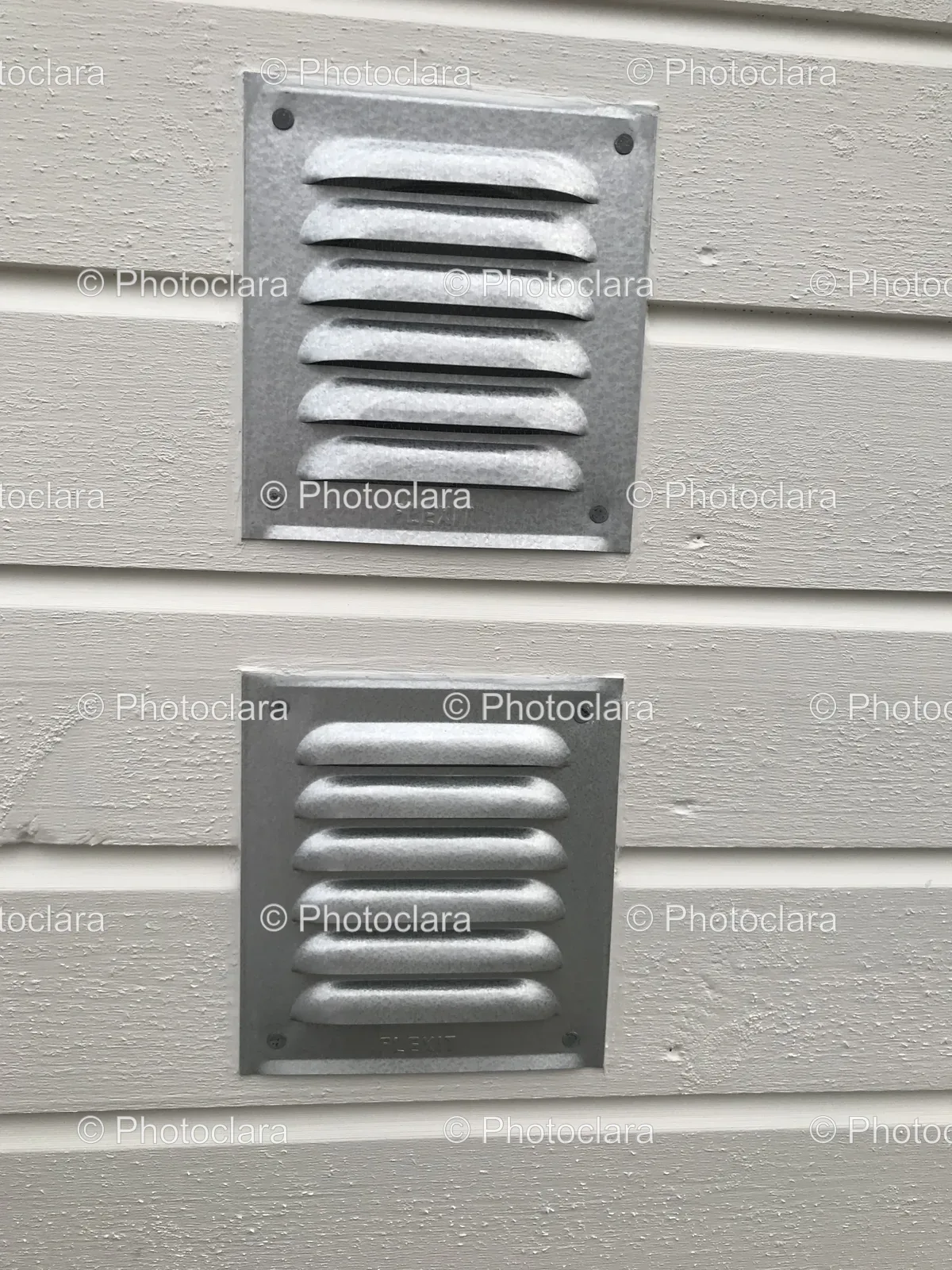grey-symmetrical-vent-covers-on-wall.jpg