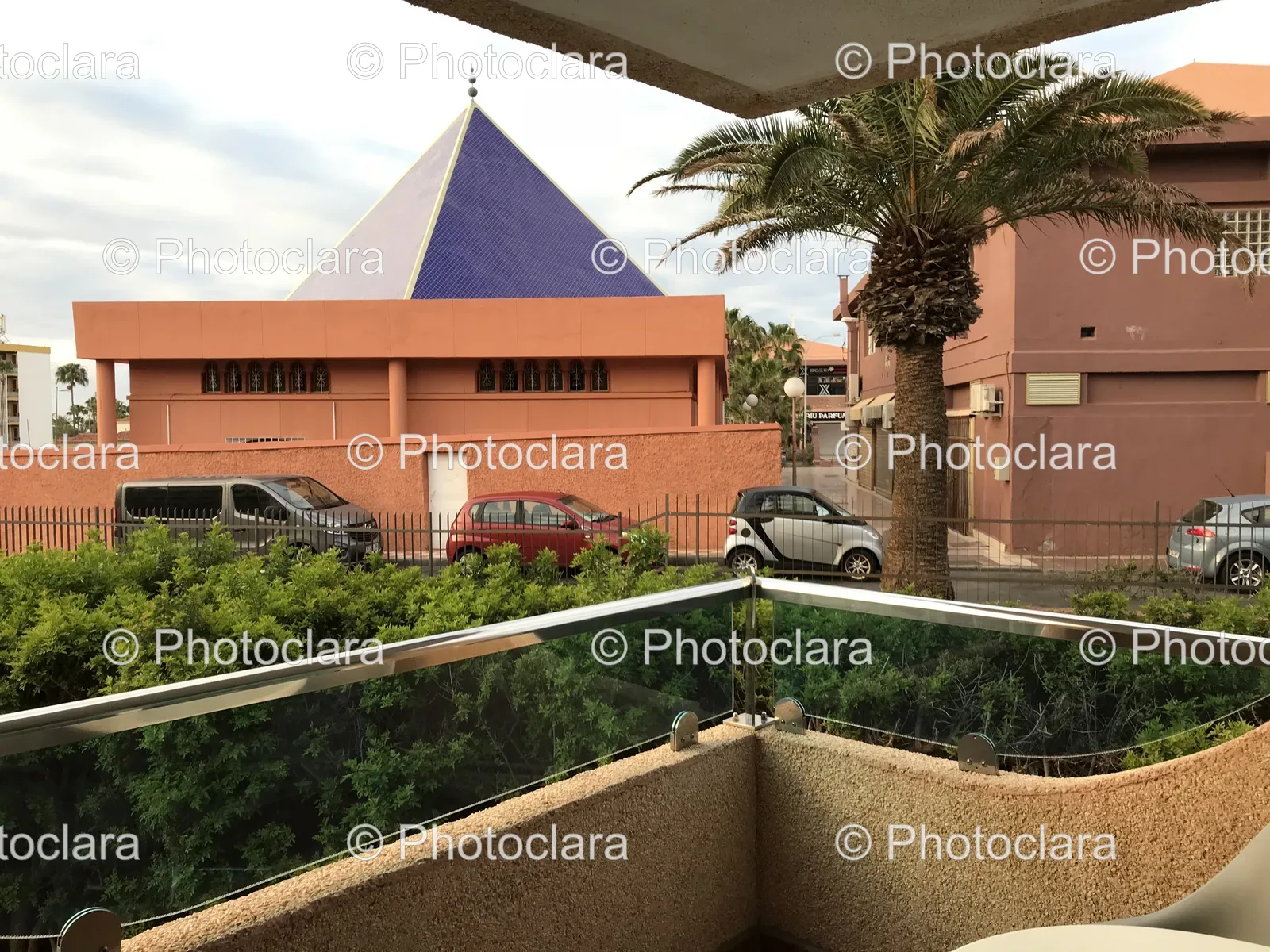 scenic-balcony-blue-triangle-roof-palm-trees.jpg
