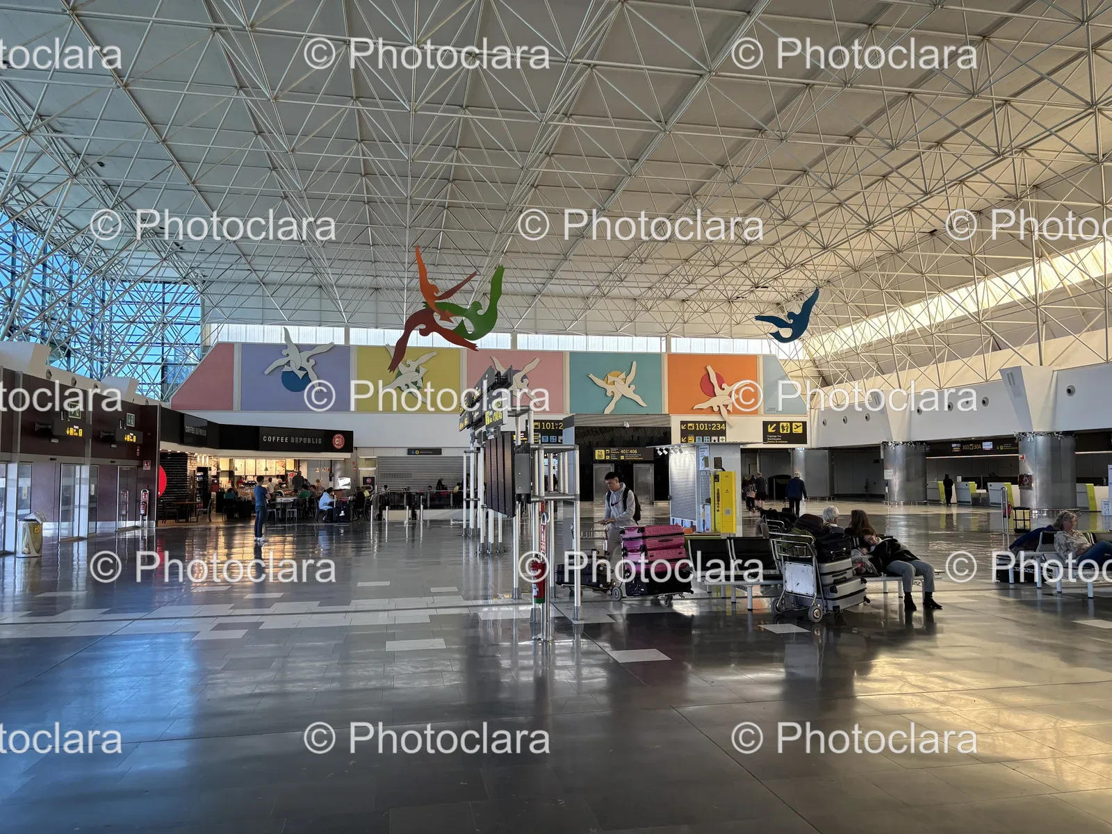 busy-airport-terminal-with-seated-travelers.jpg
