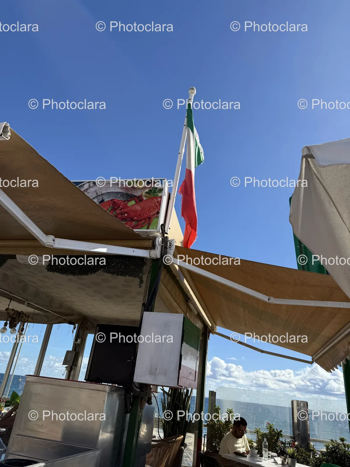 flag-displayed-on-building-against-blue-sky.jpg