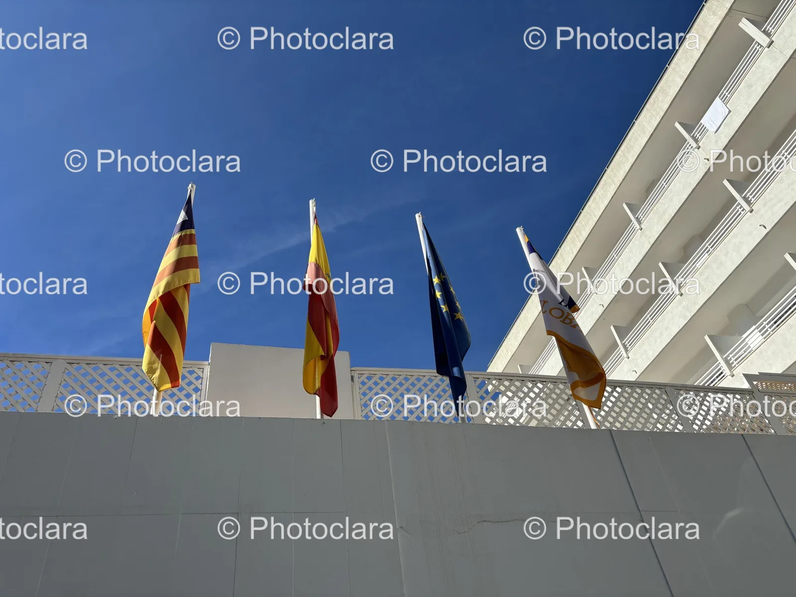 flags-on-a-civic-building-under-blue-skies.jpg