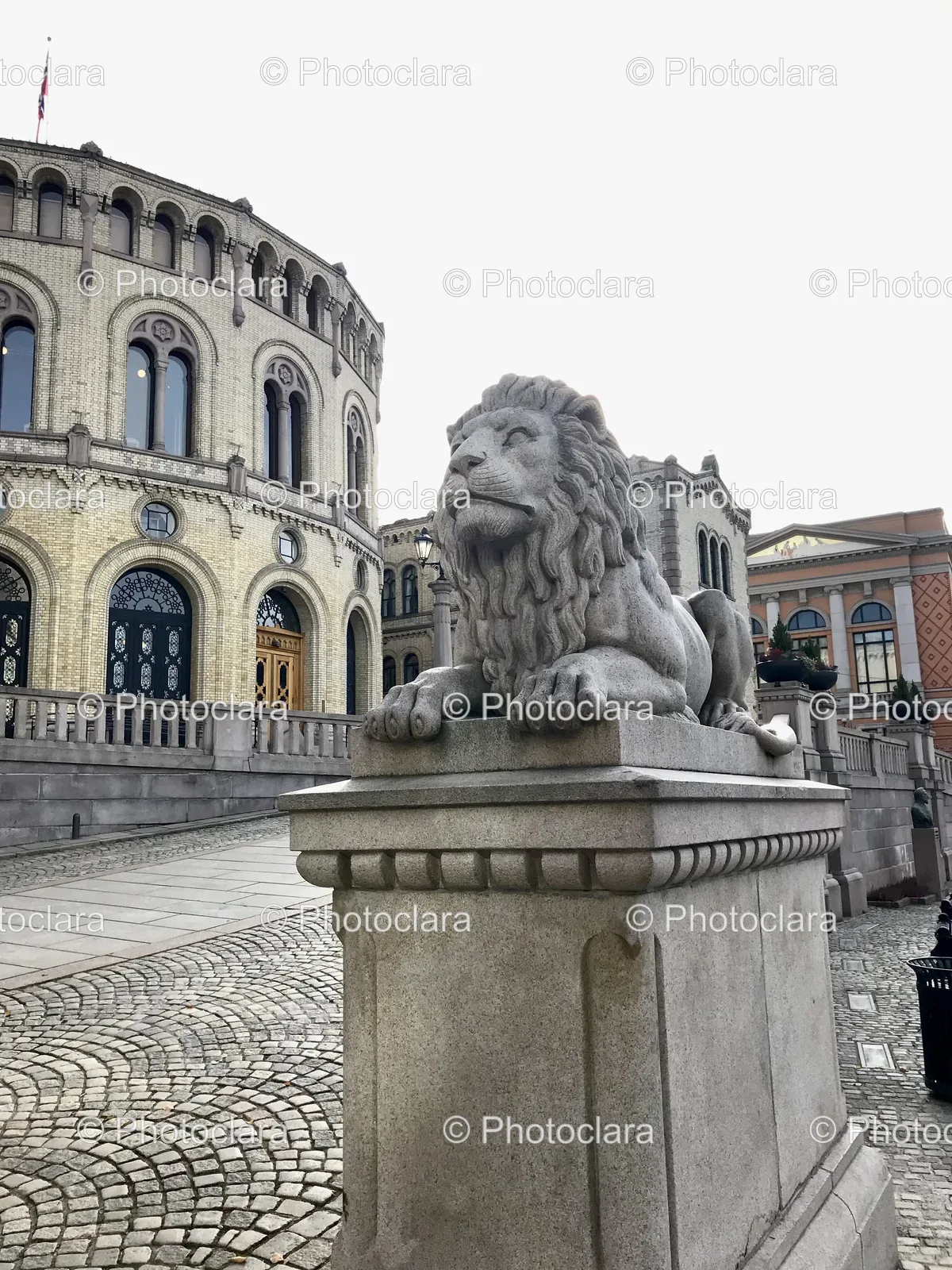 Stone-Lion-Statue-In-Front-Of-Circular-Building.jpg