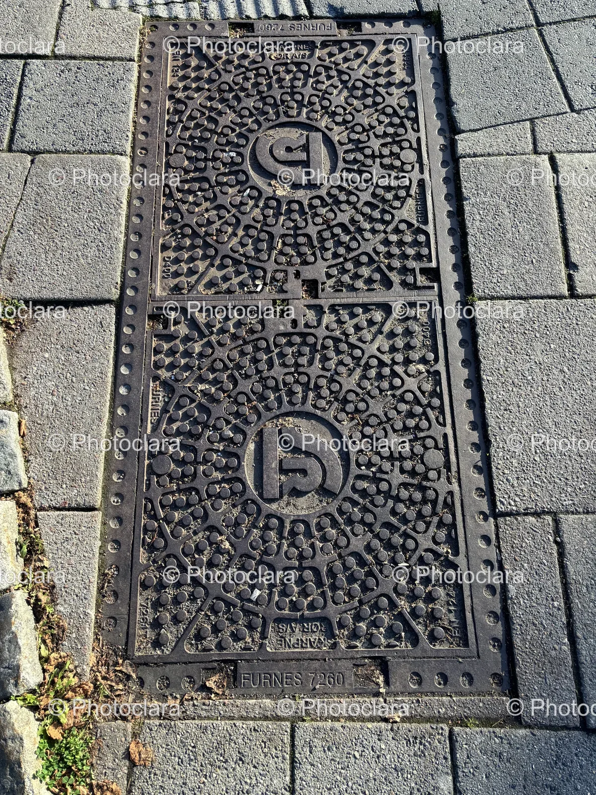 metal-drain-cover-on-sidewalk.jpg