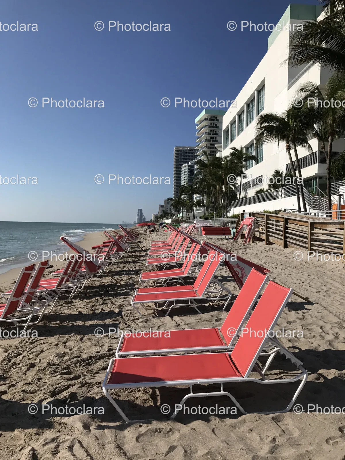Relaxing-Red-Lounge-Chairs-on-Sunny-Beach.jpg