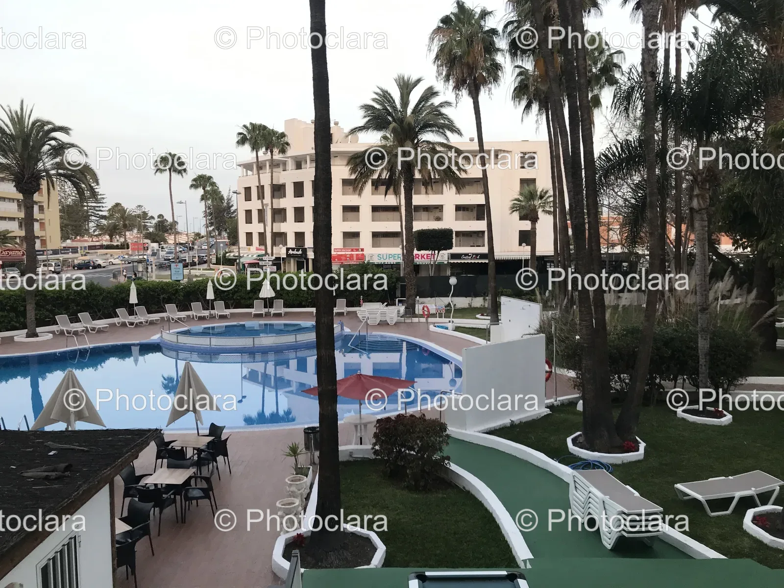 Pool-Area-with-Palm-Trees-and-Resort-Building.jpg