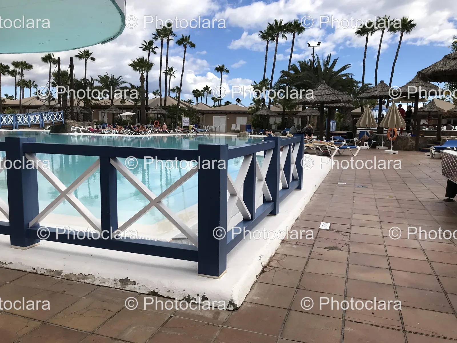 Serene-Poolside-with-Palm-Trees-and-Umbrellas.jpg