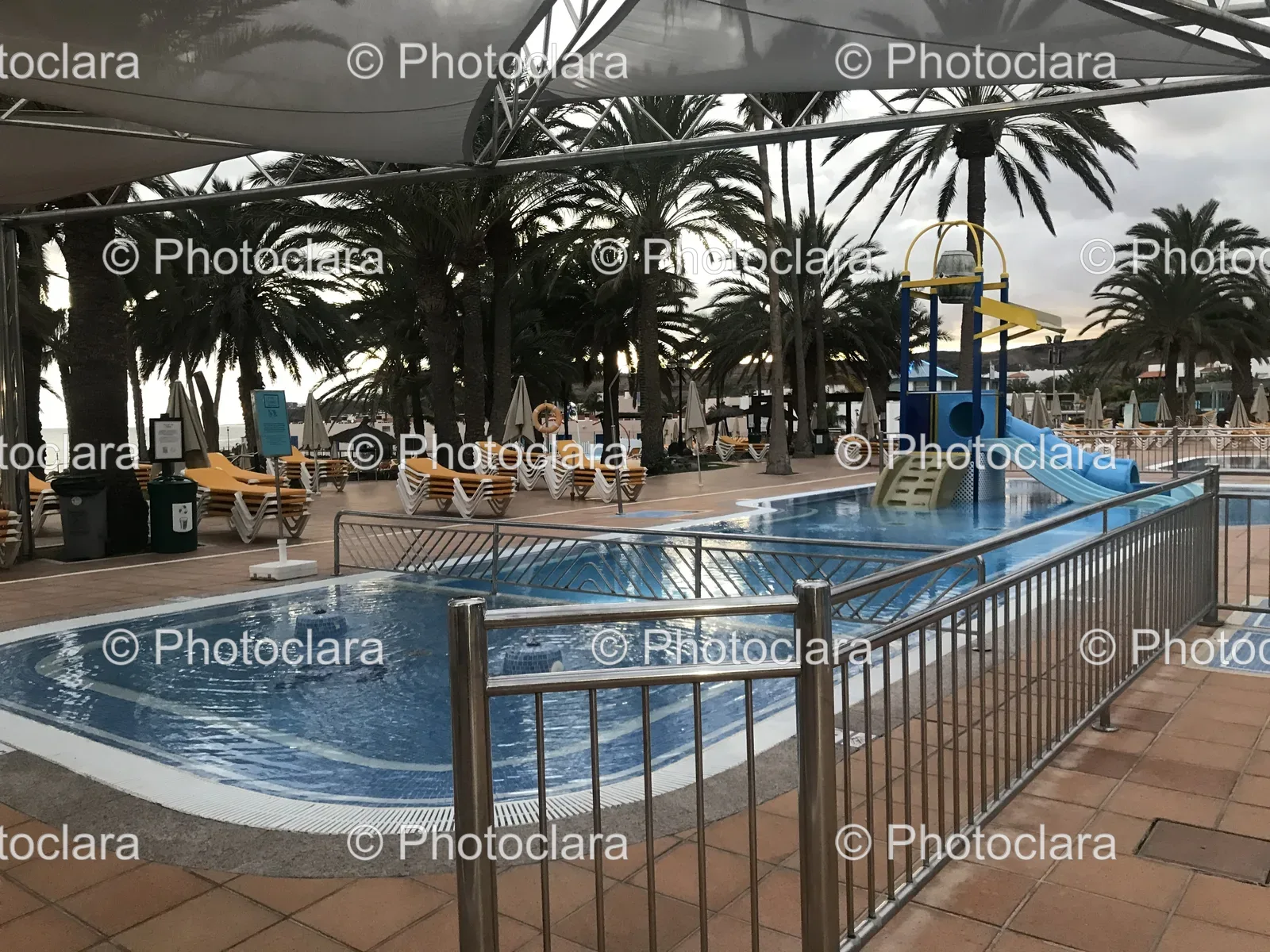 sunlit-resort-pool-with-slide.jpg