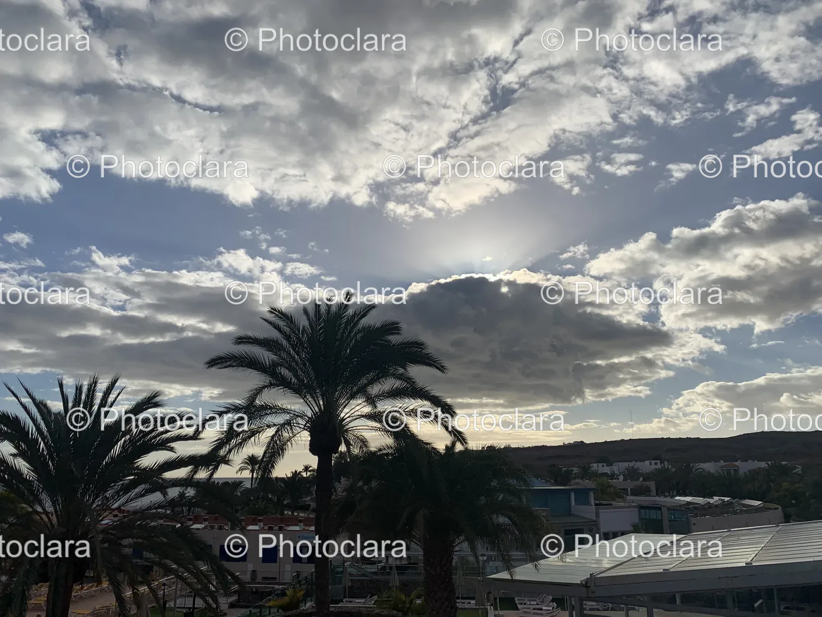 sun-shining-through-clouds-over-city.jpg