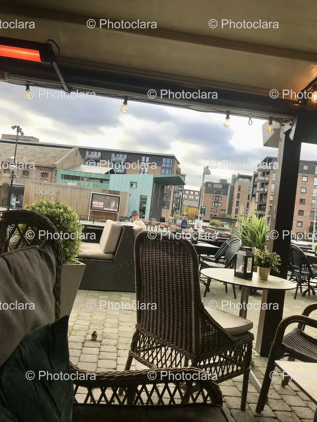 Patio-with-Chairs-and-Tables-Overlooking-Buildings.jpg