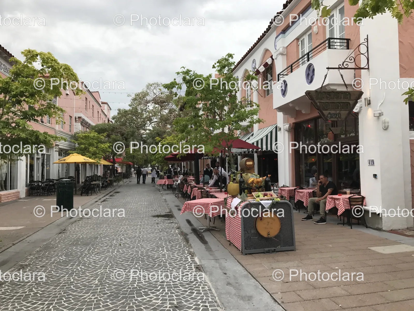 Charming-Street-With-Outdoor-Tables-And-Umbrellas.jpg
