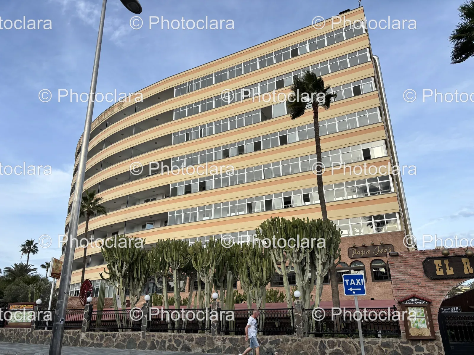 Iconic-Building-with-Palm-Trees-and-Signage.jpg
