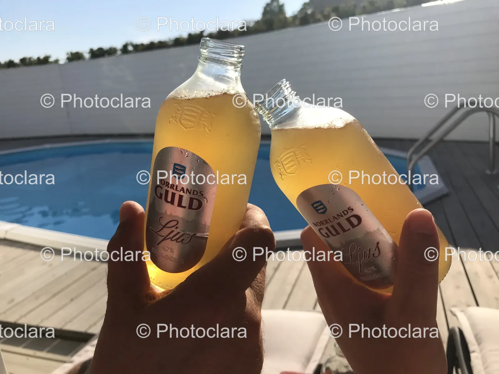 Hands-Holding-Norrlands-Guld-Beer-Bottles.jpg