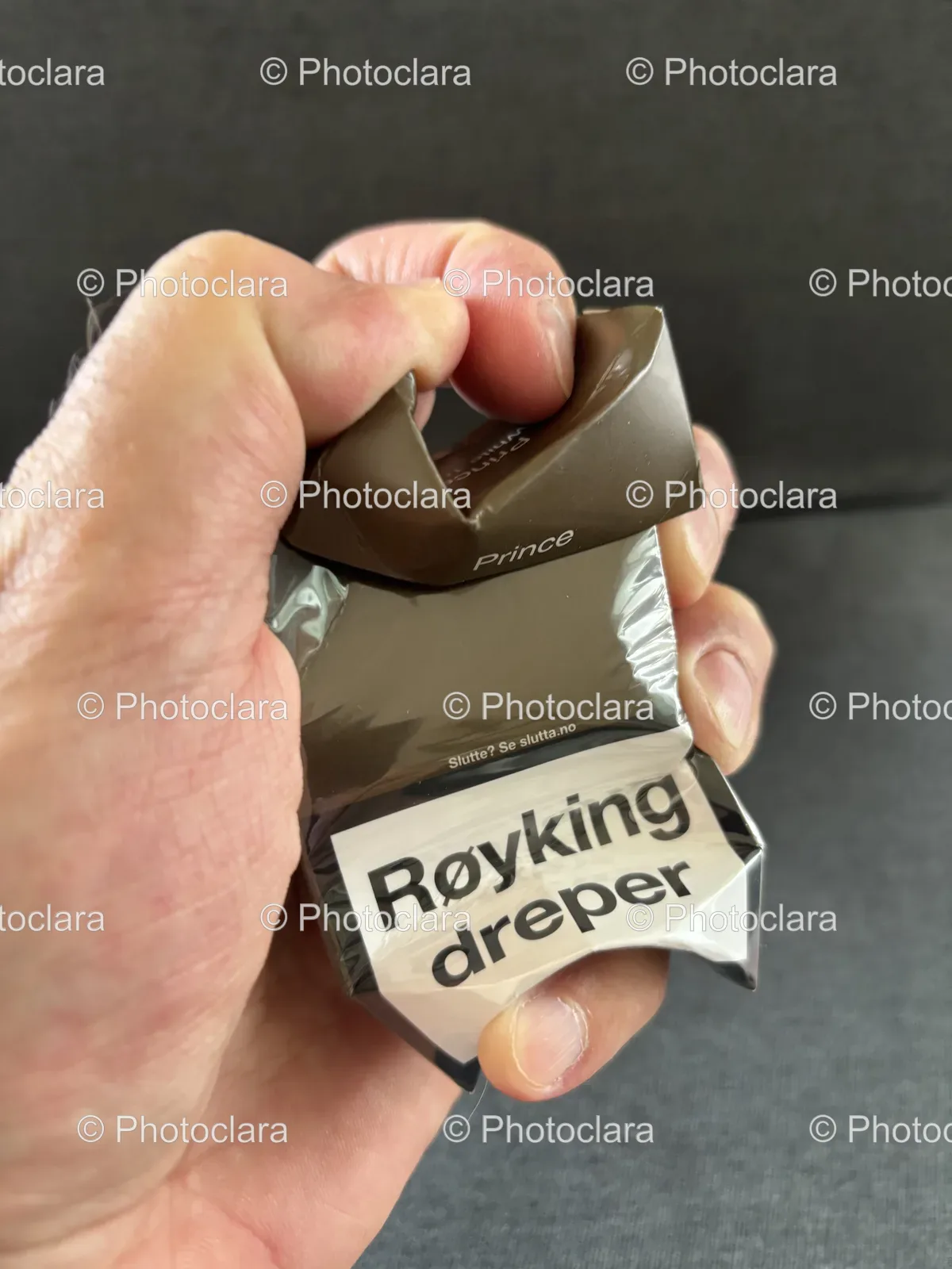 hand-holding-cigarette-package.jpg