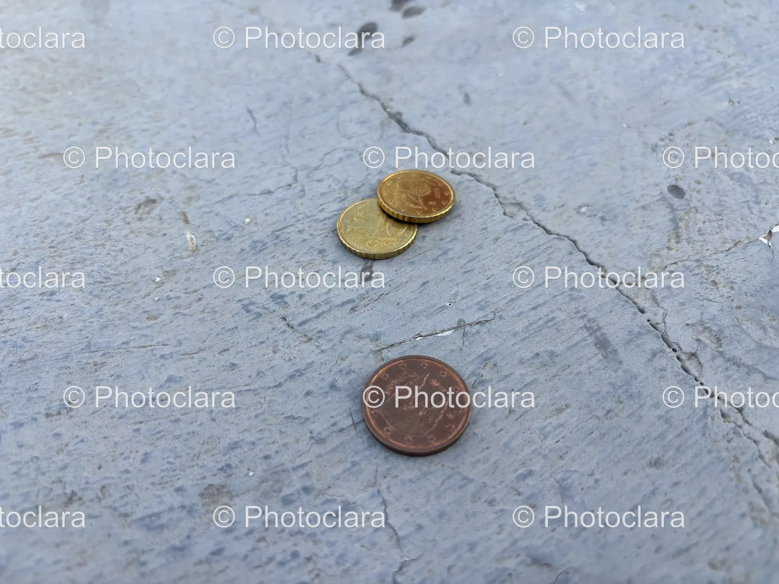 Few-Coins-on-Concrete-Surface.jpg