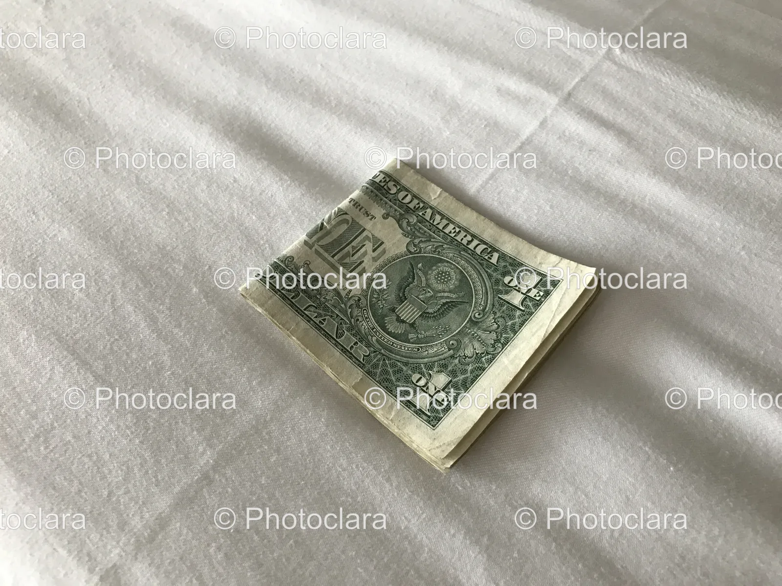 Folded-Dollar-Bill-on-White-Sheet.jpg