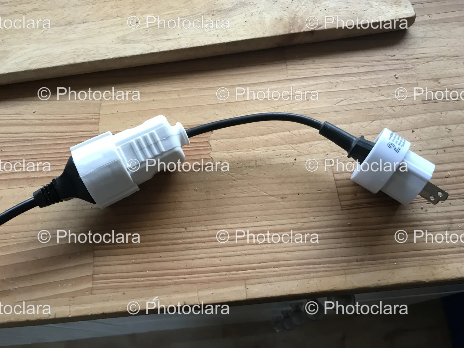 black-and-white-electrical-plugs-on-wood-surface.jpg