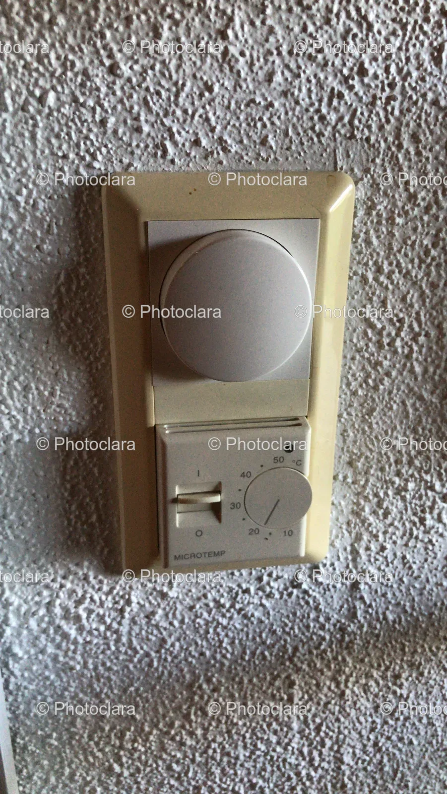 white-switch-round-knob-on-wall.jpg