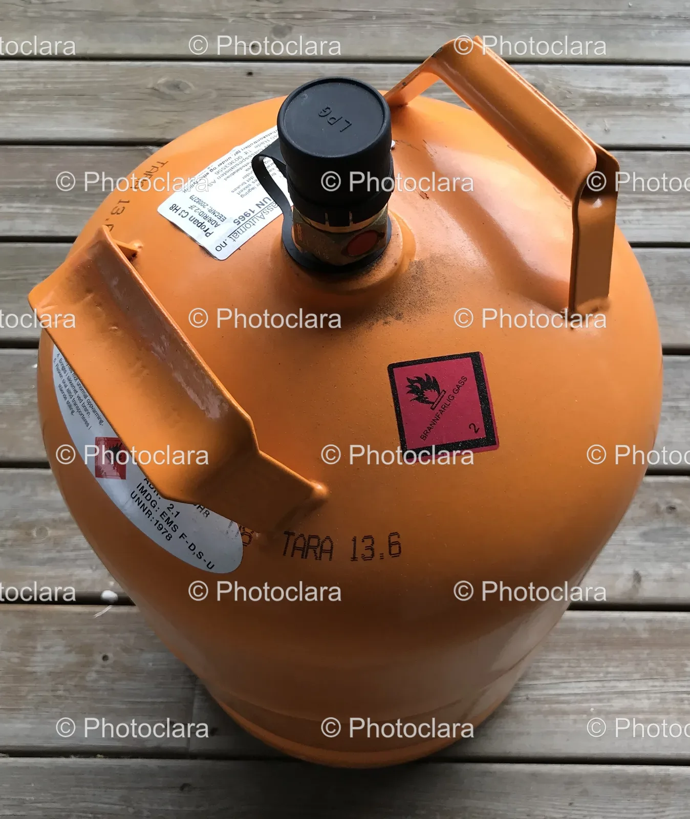 Orange-Gas-Cylinder-on-Wooden-Surface.jpg