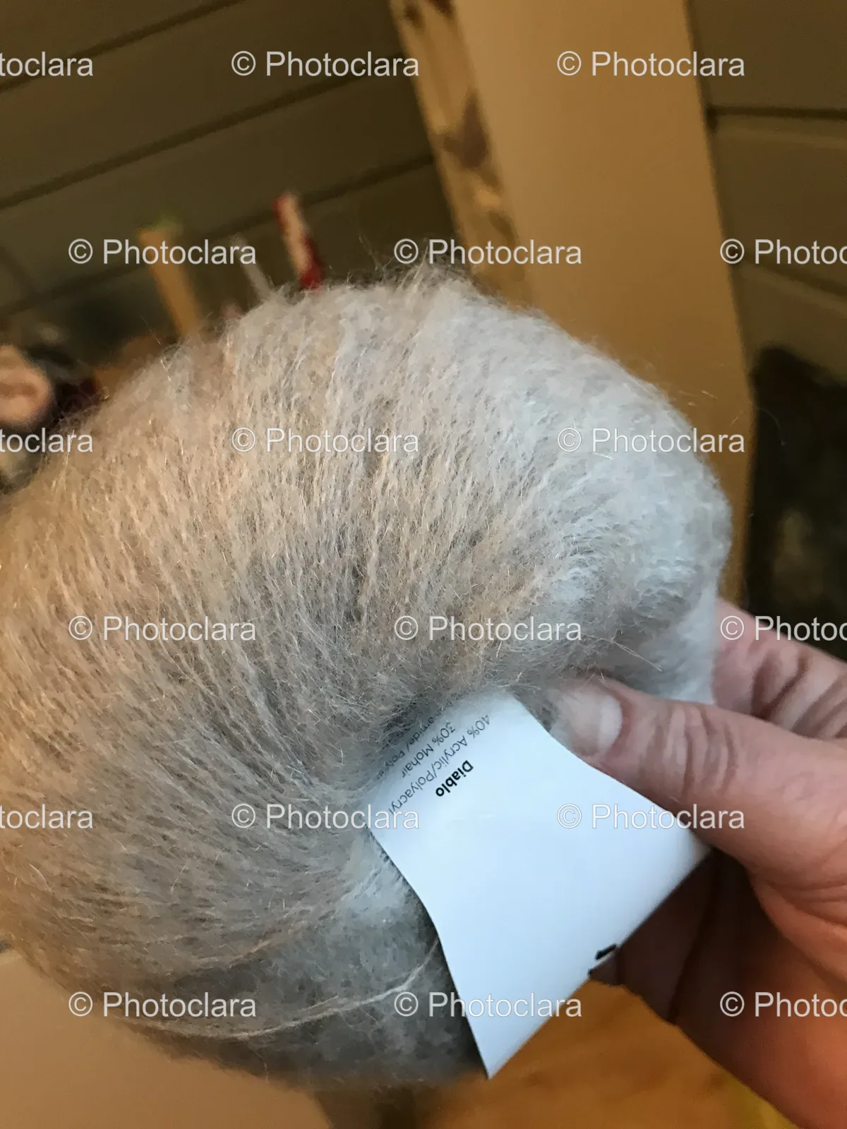 Person-Holding-a-White-Tag-with-Material-Composition.jpg
