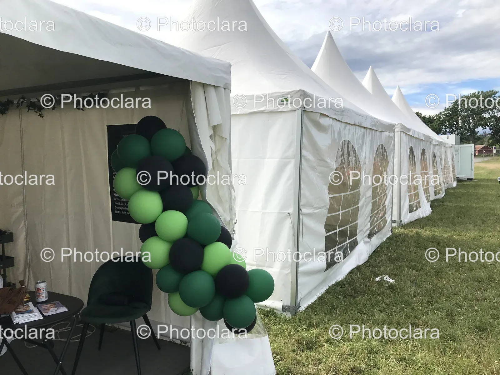 white-tents-green-black-balloons.jpg