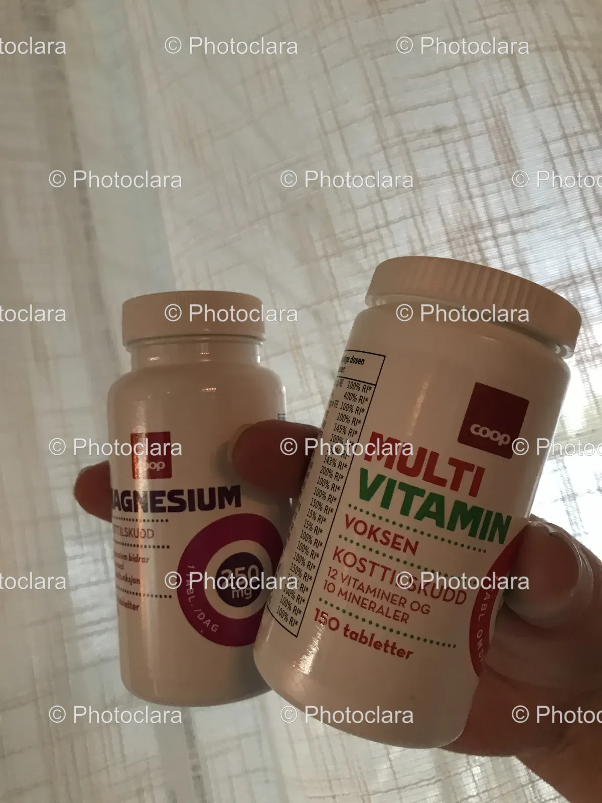 hand-holding-two-recyclable-beverage-bottles.jpg