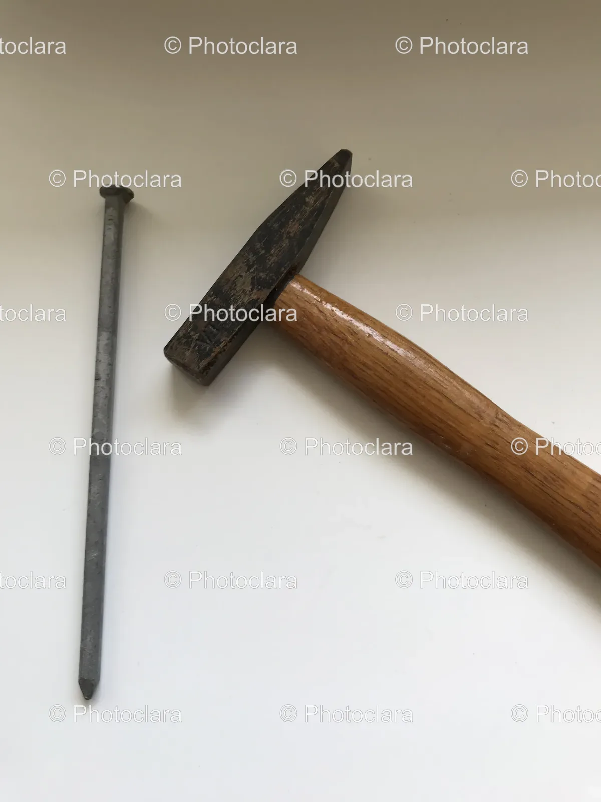 hammer-nail-on-white-surface.jpg