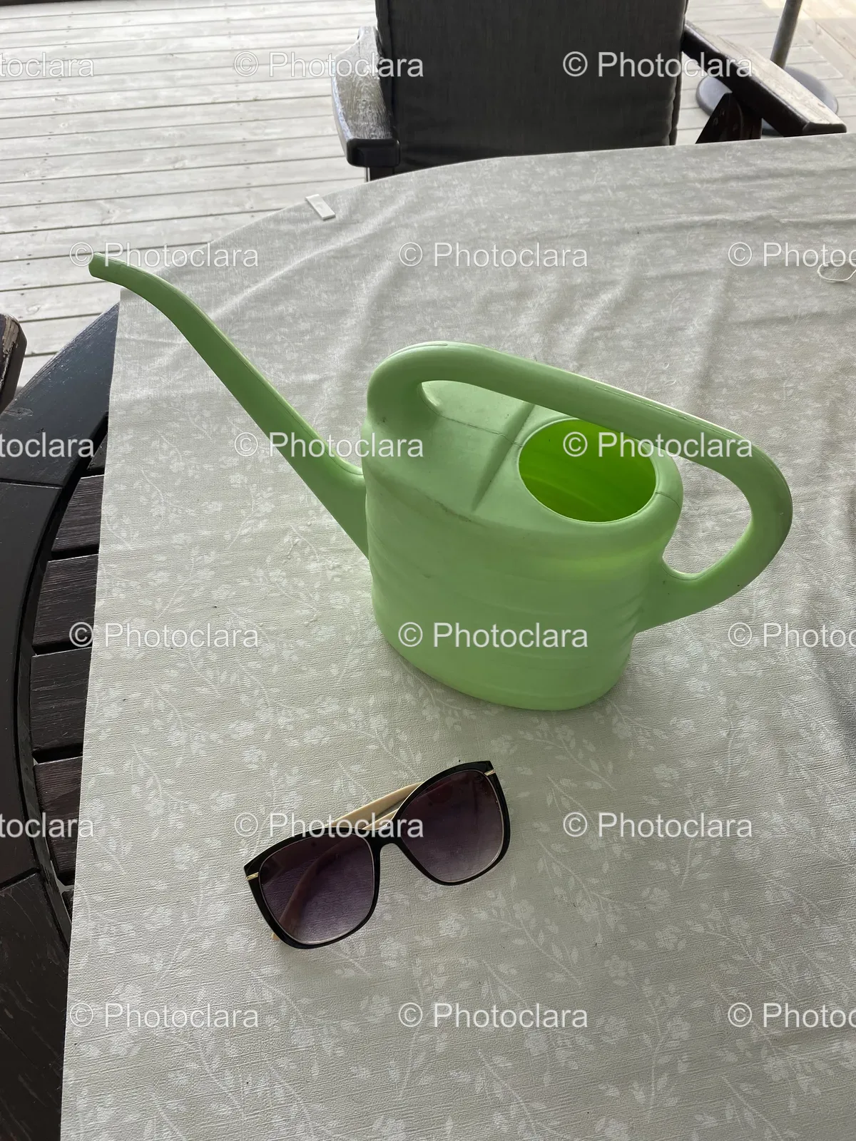 Green-Watering-Can-and-Sunglasses-on-a-Table.jpg