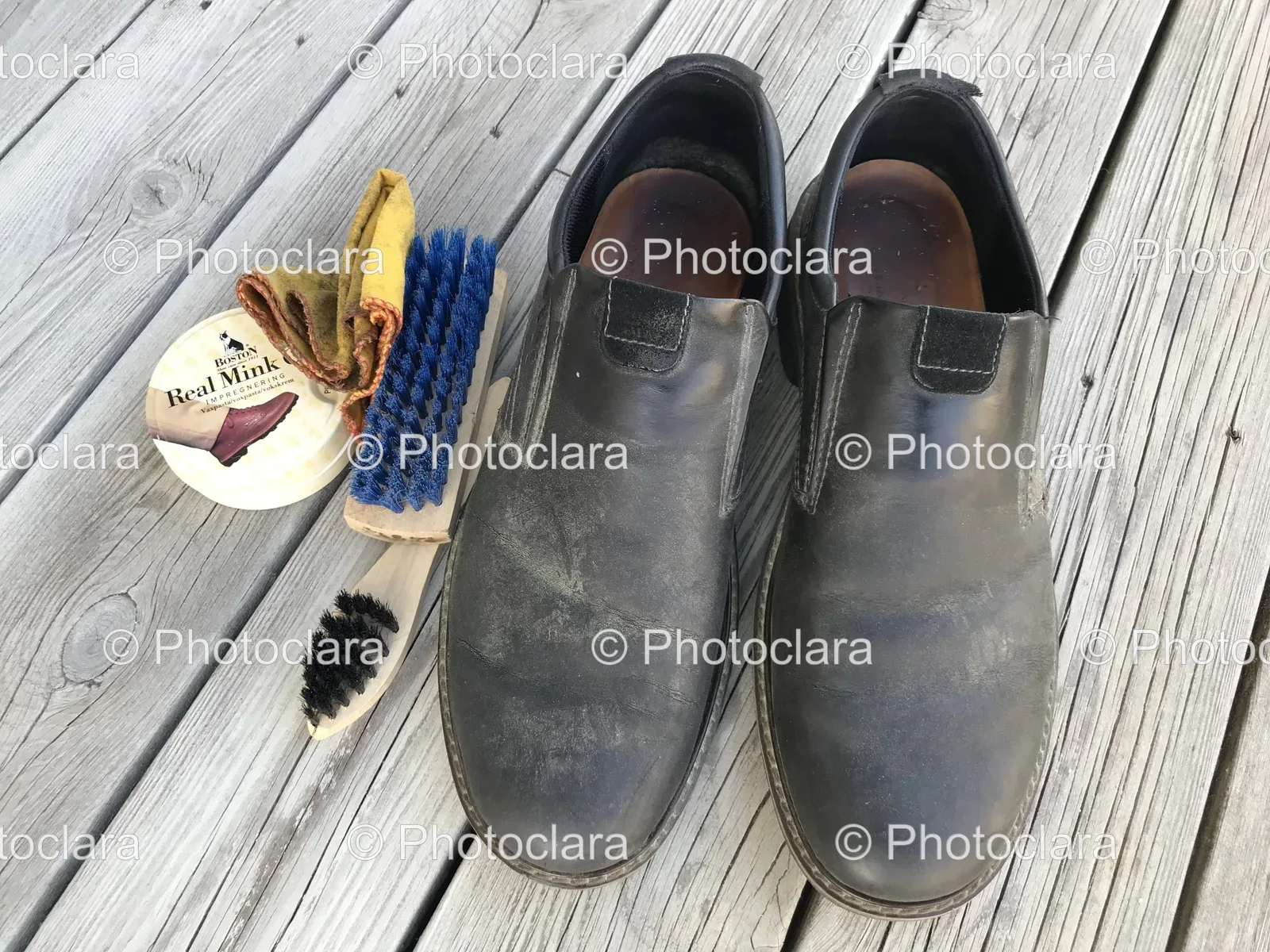 Black-Shoes-and-Brush-on-Wooden-Surface.jpg
