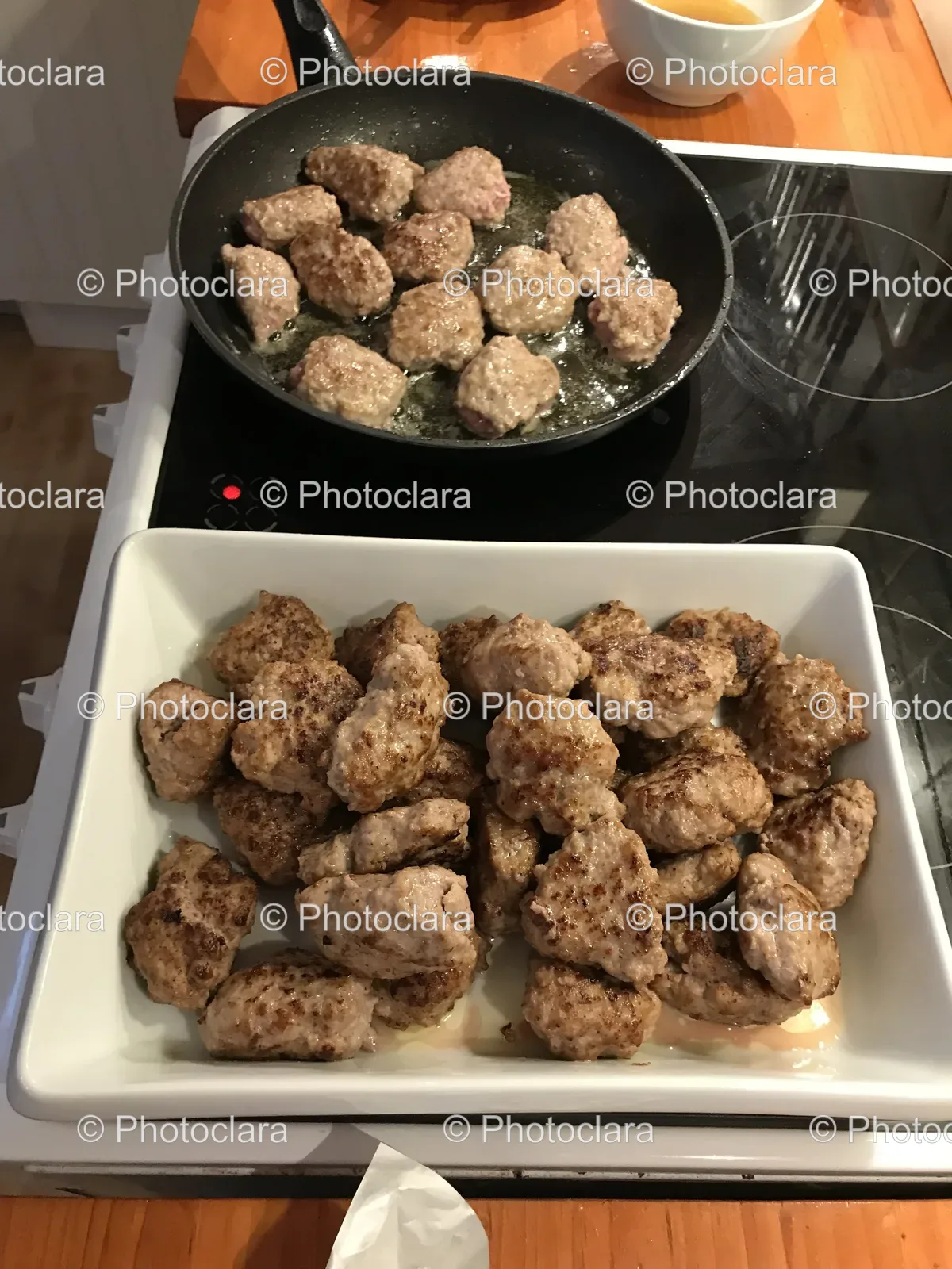 pans-of-meat-cooking-on-a-stove.jpg