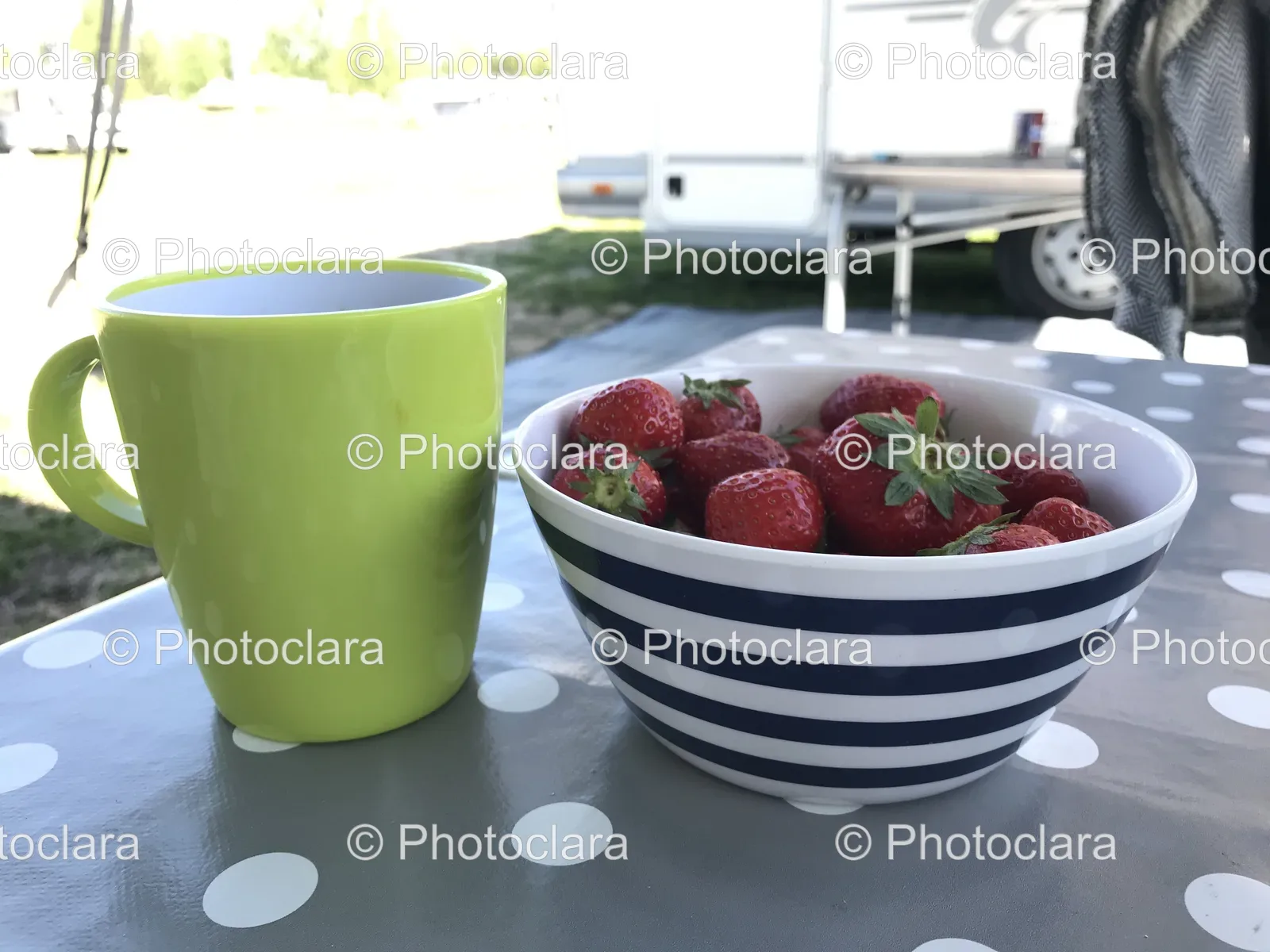 bowl-of-fresh-strawberries-and-mug-on-table.jpg