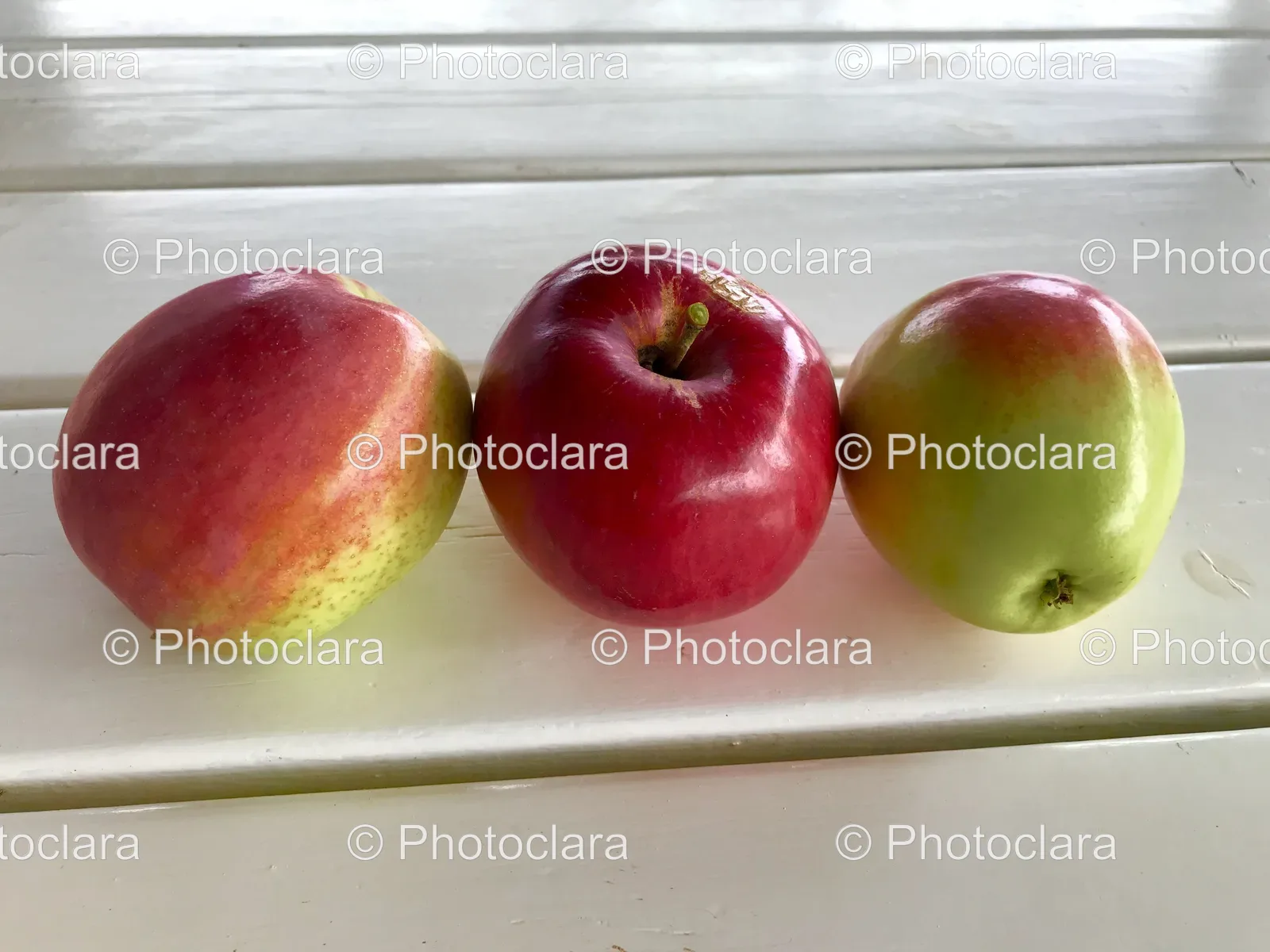 Group-of-Fresh-Apples-on-White-Surface.jpg