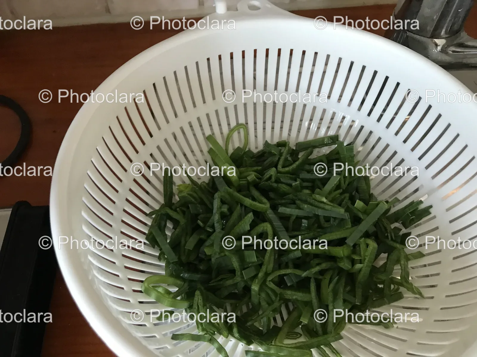 Fresh Green Vegetables in a White Colander