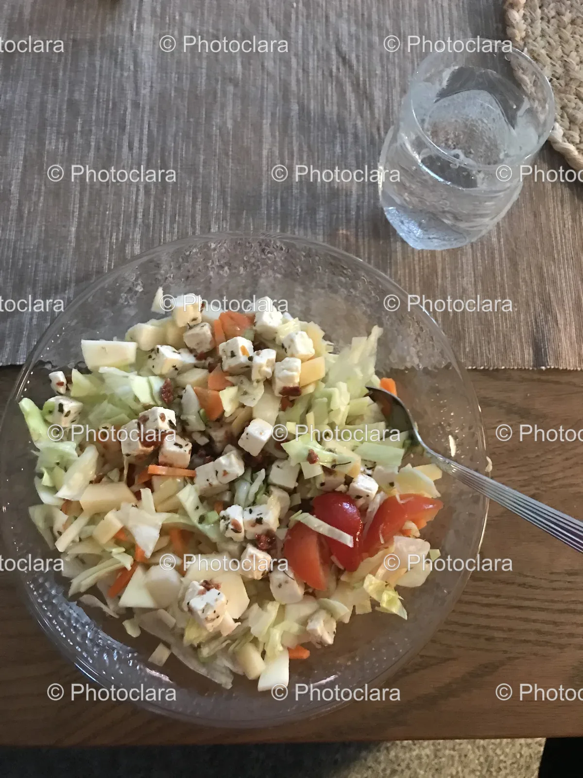 Fresh Salad Bowl with Spoon and Glass of Water