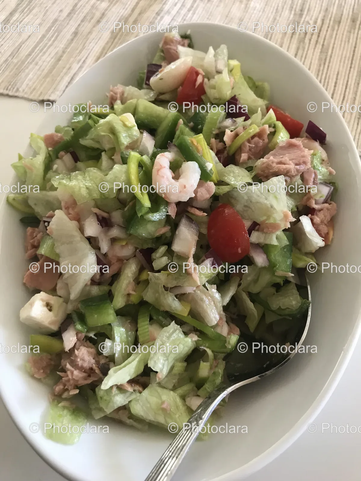 A Bowl of Salad with a Spoon