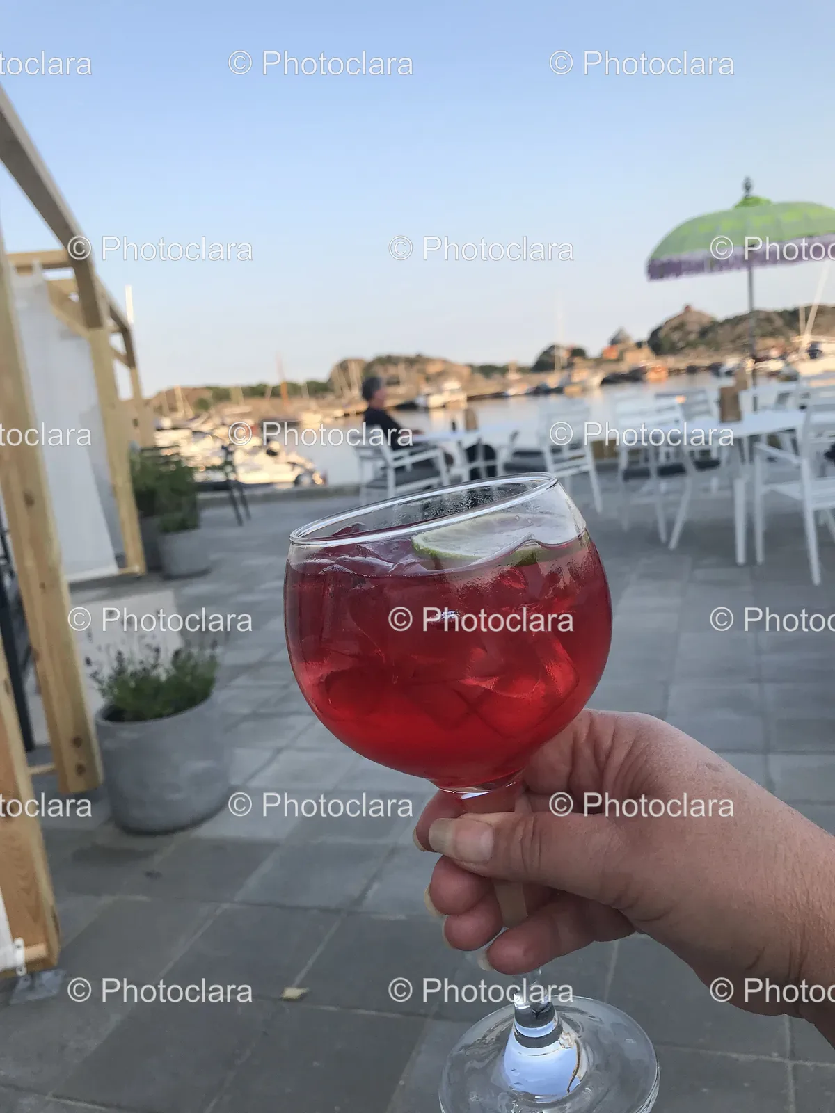 Hand-Holding-Red-Cocktail-With-Lime.jpg