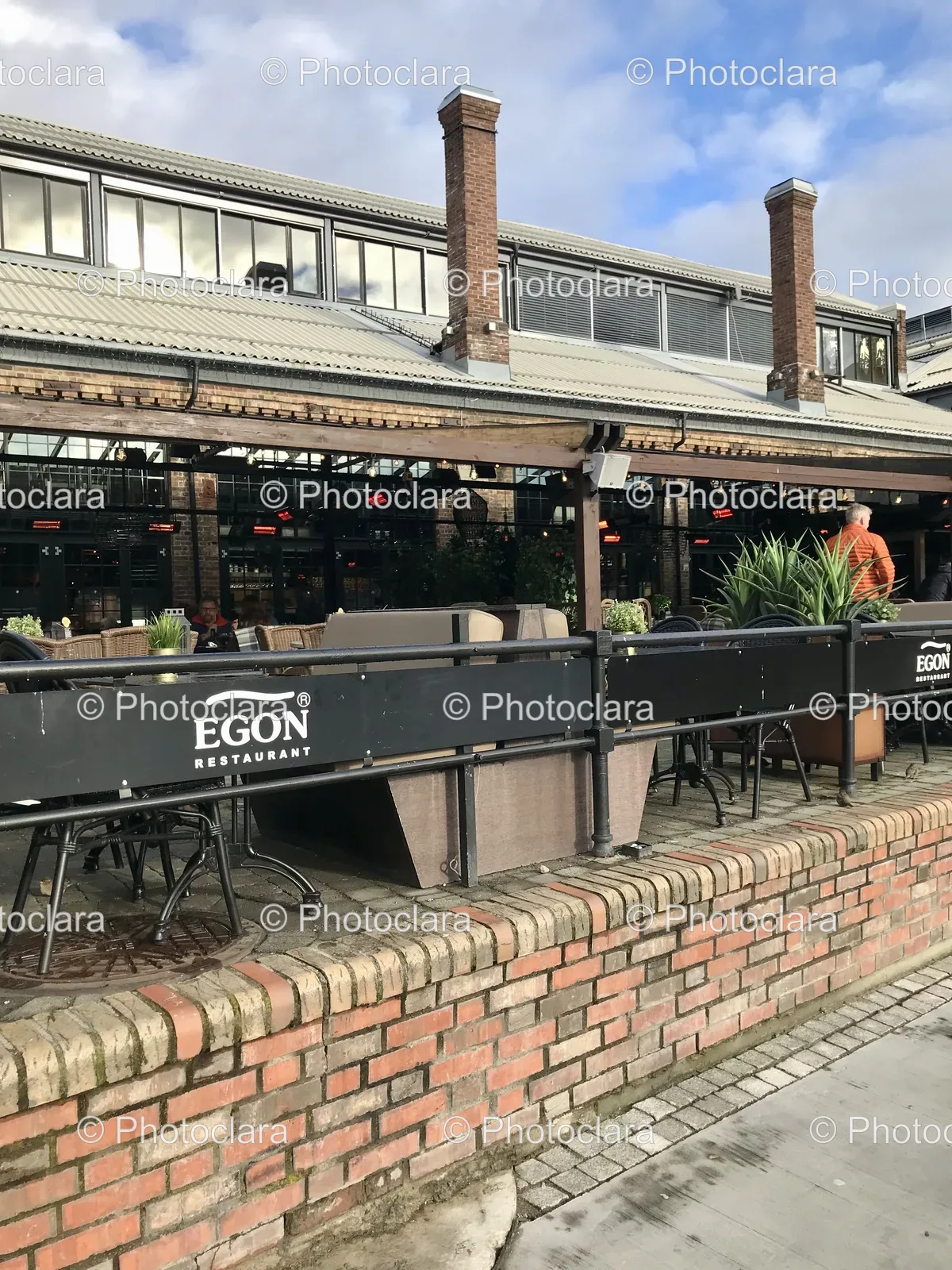 Charming-Restaurant-Setting-Brick-Wall-Black-Railing.jpg