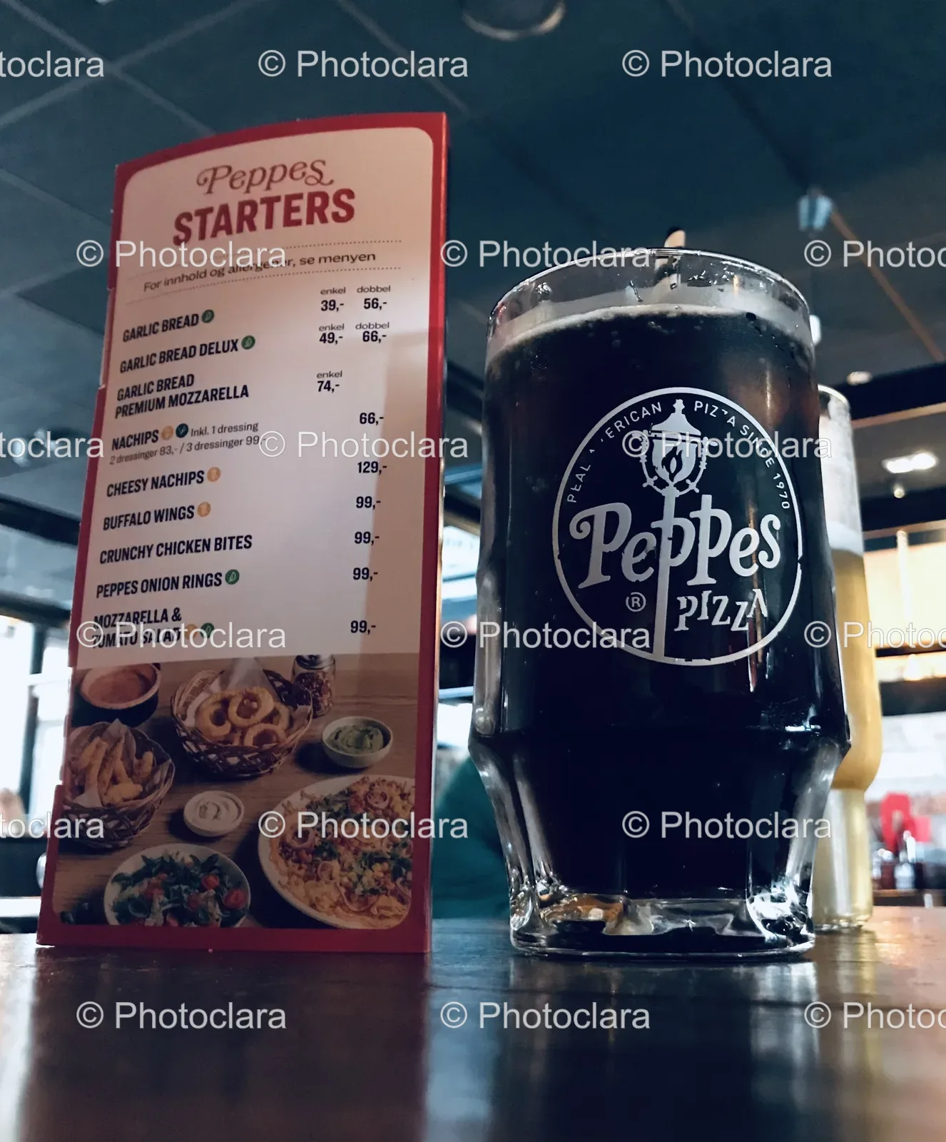 Glass-of-Dark-Liquid-Next-to-Peppes-Menu.jpg