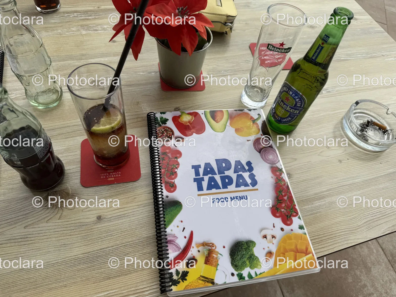 Day-on-the-Table--Notebook-and-Glasses-Amidst-Beverage-Choices.jpg