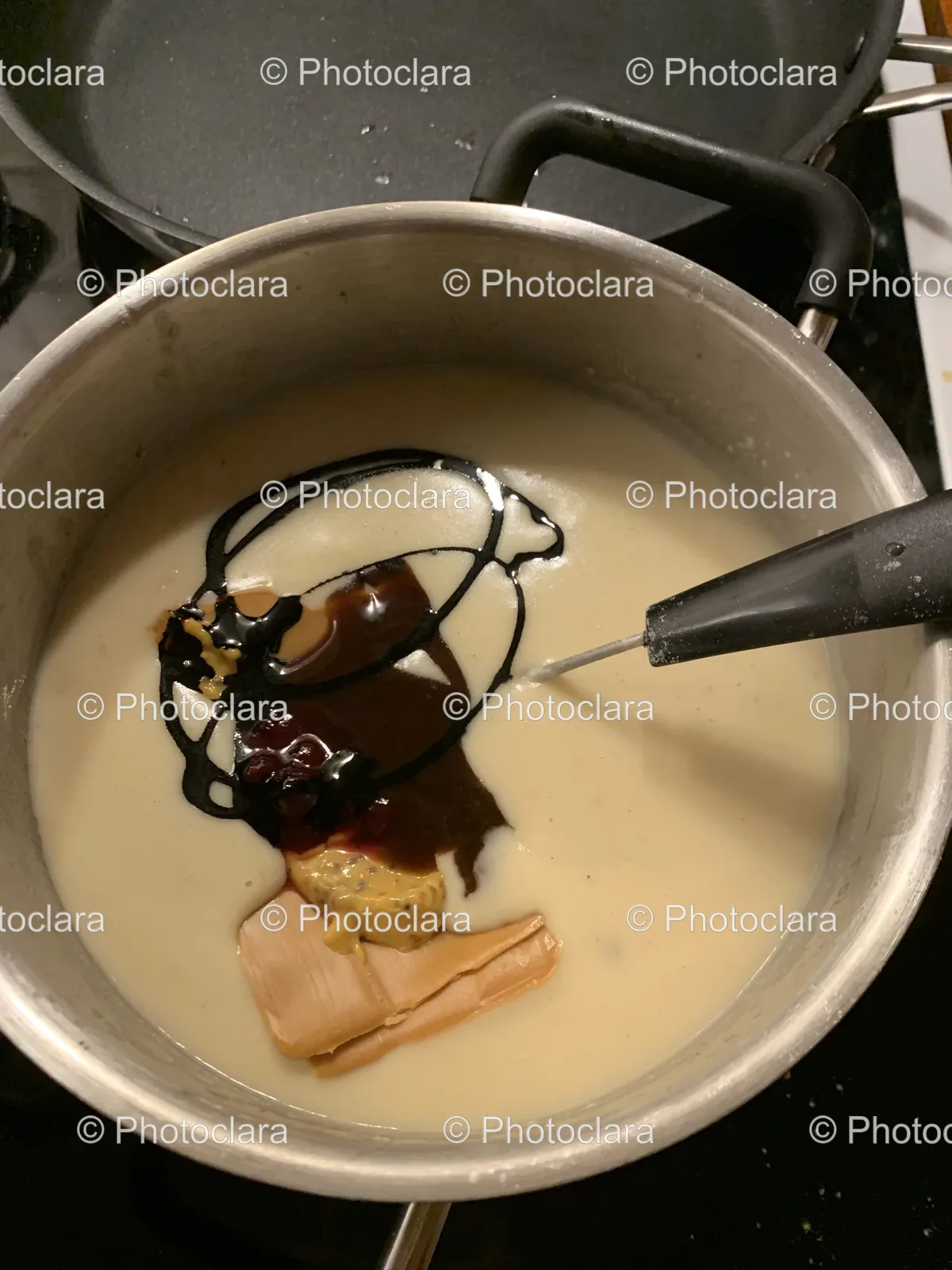 Pot-of-Food-on-Stovetop-with-Sauce-and-Spatula.jpg