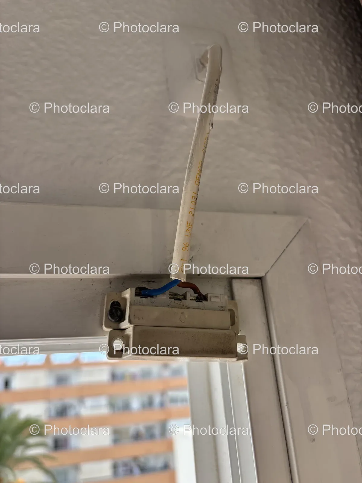 White-Object-with-Blue-Wire-and-Window-View.jpg