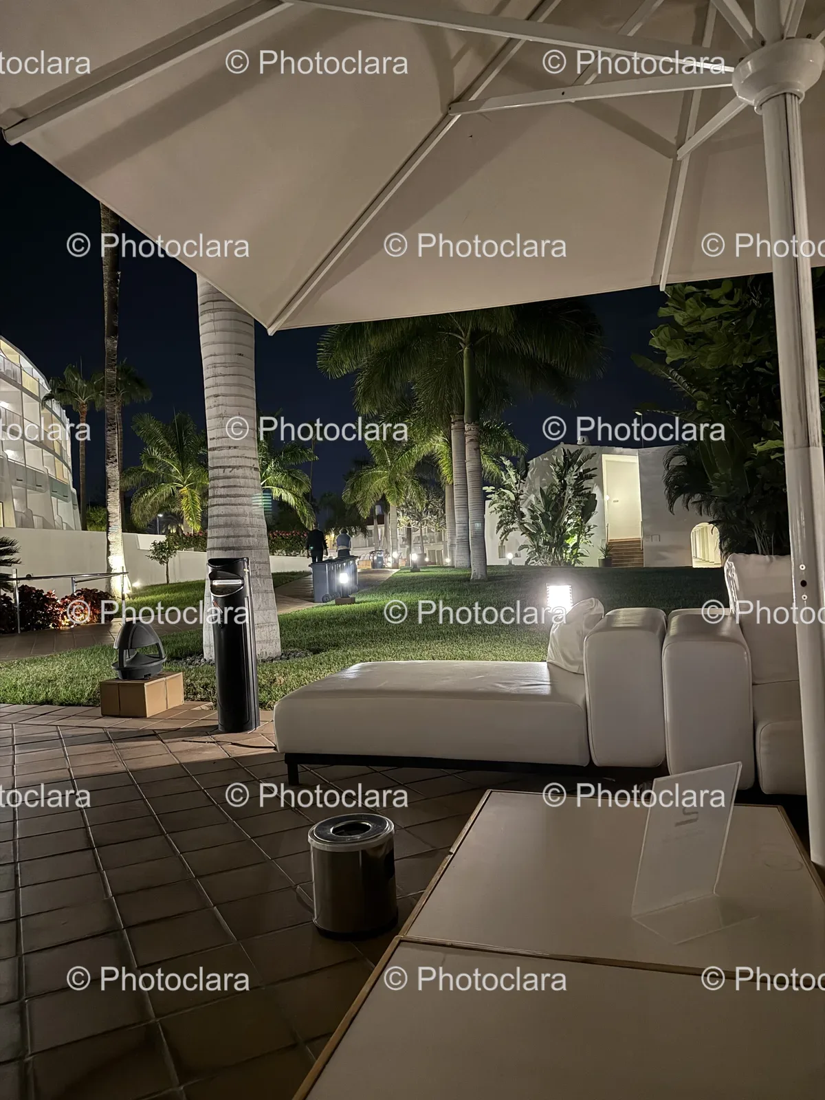elegant-patio-setting-white-couch-umbrella.jpg