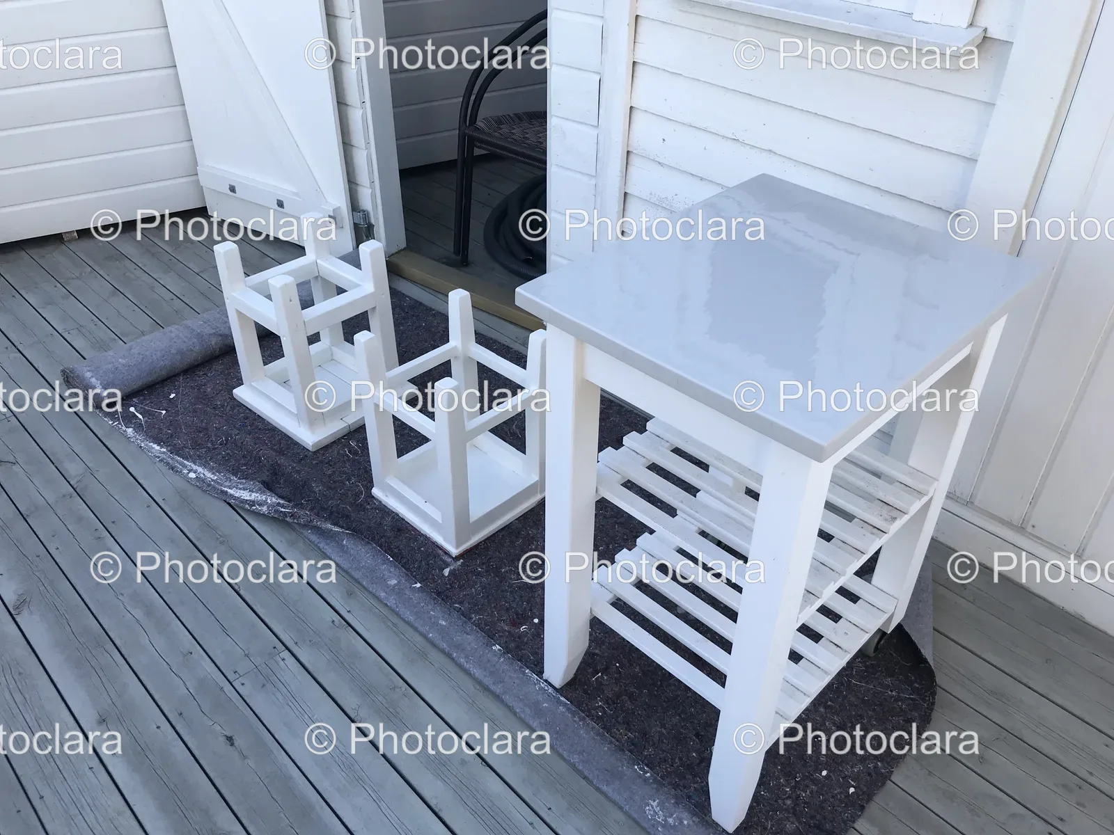 White-Table-and-Chairs-on-Wooden-Deck.jpg
