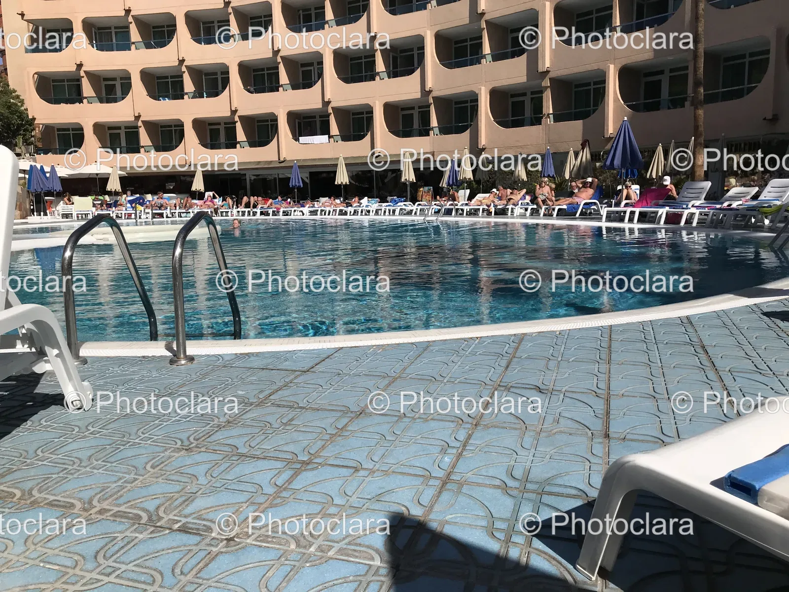 Poolside-Relaxation-with-Chairs-and-Umbrellas.jpg