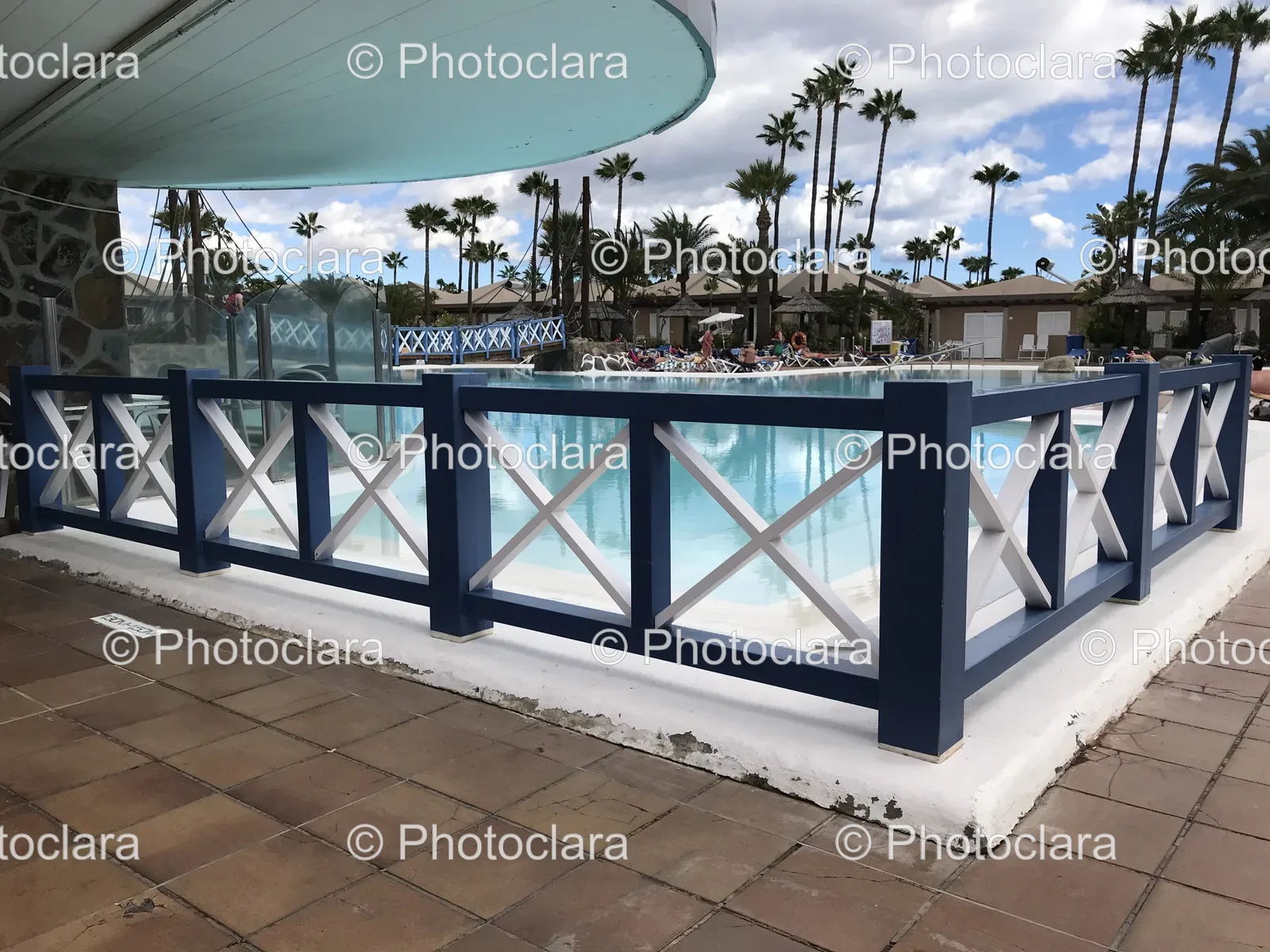 scenic-poolside-with-palm-trees-and-fence.jpg