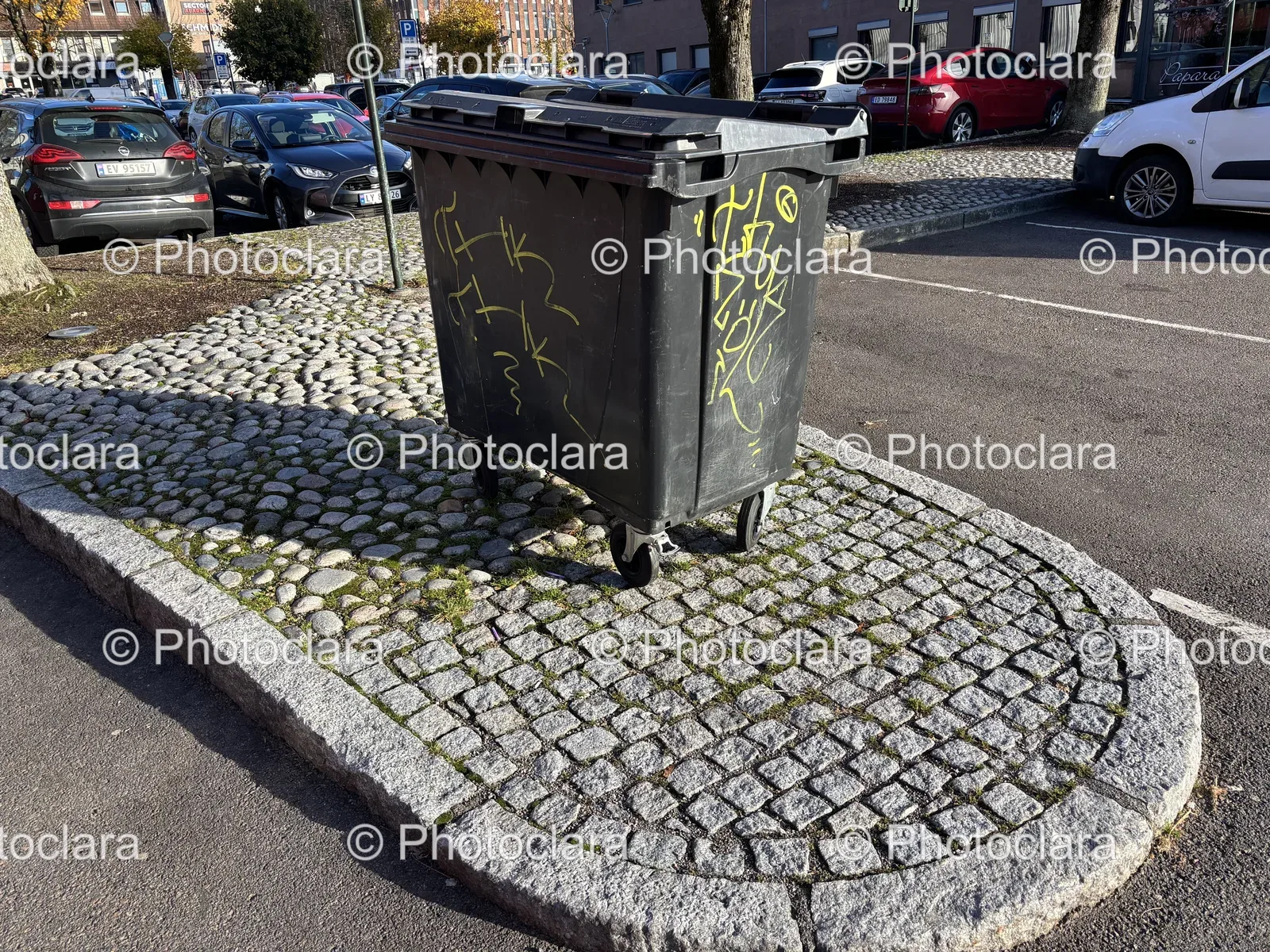 black-trash-can-on-stone-surface.jpg