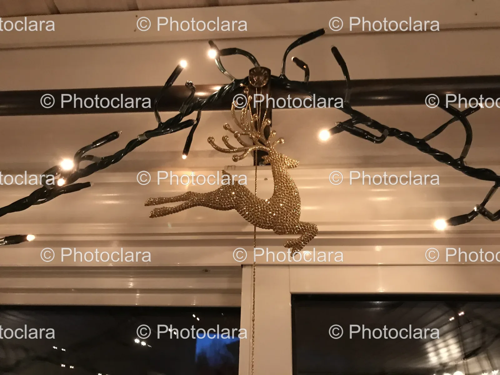 Gold-Reindeer-Ornament-Hanging-from-Metal-Bar.jpg